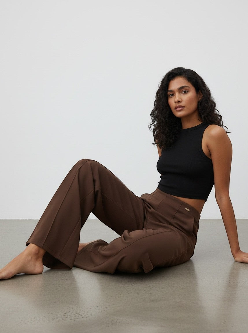 Model wearing duwies chocolate brown high-waisted wide-leg trousers with front seam detail and a black tank top